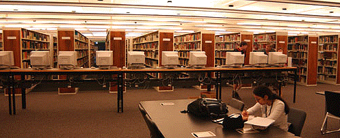 [Computers in foreground, bookcases behind]