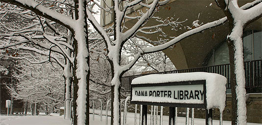 [Library sign heavy with snow]