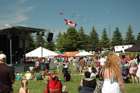 A large Canadian flag flies over the main stage at UW's 24th annual Canada Day celebration at Columbia Lake.