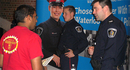 [Two live officers and one on a poster]