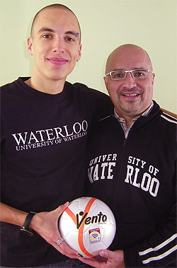 [Father and son with futsal ball]