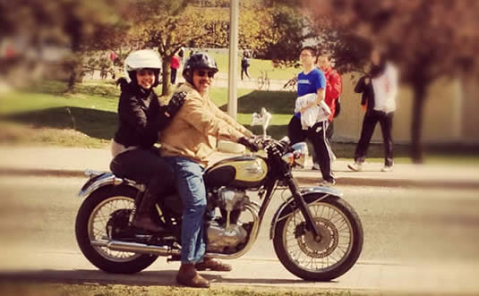 Anam Khan and Carlos Radic on a motorcycle.