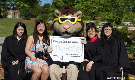 New grads pose with King Warrior before the convocation ceremony on June 15, 2012