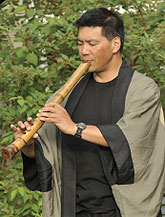A man playing a shakuhachi.