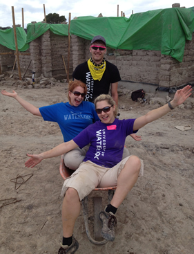 Erin Smith, Michelle Burlock, and Steve Krysak and a wheelbarrow in Honduras.