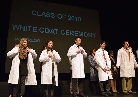 Pharmacy students participate in a robing ceremony.