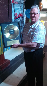 JJ with his golden record at the Bombshelter Pub.