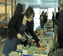 A woman looks at books for sale.