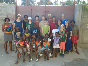 A group photo of EMI volunteers and Haitian schoolchildren.