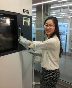 Genie Kim prepares to open a 3D printer.