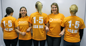Volunteers show off the mental health wellness day t-shirts.