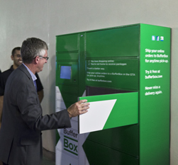 Gary McNeil, president of GO Transit, uses the first Toronto BufferBox while co-founder Jay Shah looks on.