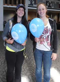 United Way student volunteers hand out balloons in the Student Life Centre.