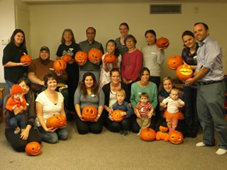 International Spouses members pose with their jack o'lanterns.