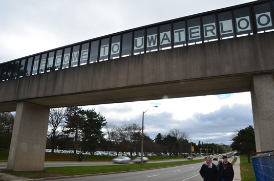 A welcome to uWaterloo image on the pedestrian bridge over University Avenue.