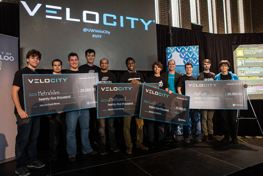 Latest VeloCty winners pose with their oversize cheques.