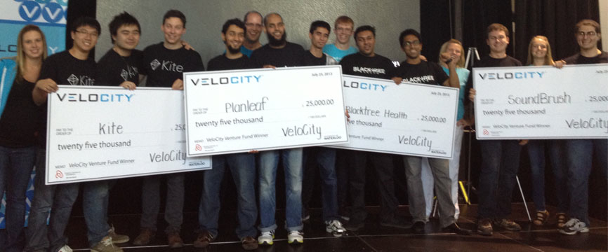 Winners of the latest VeloCity Venture Fund pose with oversize cheques.