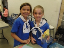 Two girl guides prepare to launch a bottle rocket.